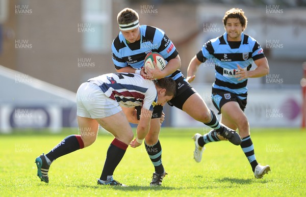 290912 - Cardiff v Swansea - Principality Premiership -Thomas Davies of Cardiff is tackled by Nick Harwood of Swansea