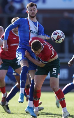 050425 - Carlisle United v Newport County - Sky Bet League 2 - Joe Hugill of Carlisle clutches James Clarke of Newport to prevent him closing in on header