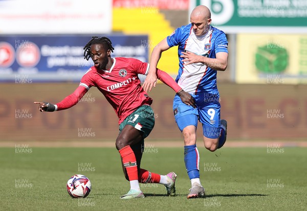 050425 - Carlisle United v Newport County - Sky Bet League 2 - Cameron Antwi of Newport tackles Georgie Kelly of Carlisle