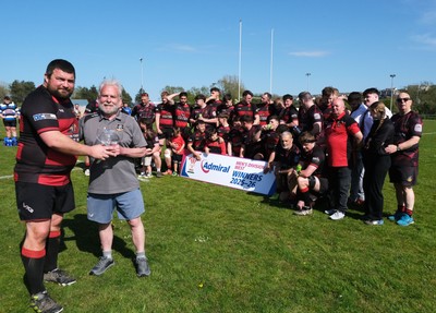 250426 - Fishguard v Carmarthen Athletic - Admiral National League 2 West - Carmarthen Athletic captain Richard Davies is presented with the league trophy by Carmarthen Athletic President Dr Chris John