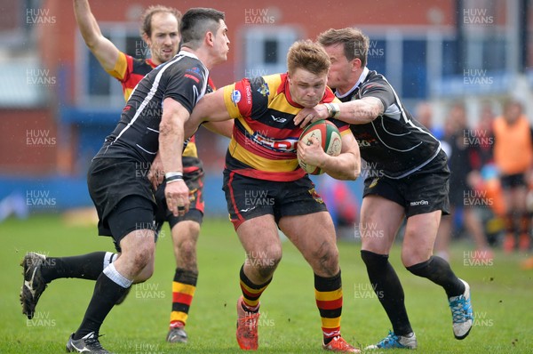 010417 Carmarthen Quins v Bedwas - Fosters Challenge Cup Final - Morgan Griffiths of Carmarthen Quins bursts out of Aaron Bramwell and Matthew John of Bedwas tackle