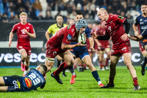 091223 - Castres Olympique v Scarlets - EPCR Challenge Cup - Jonathan Davies of Scarlets is tackled by Theo Chabouni of Castres 