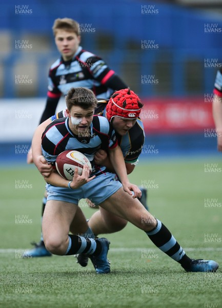 061217 - Cardiff and Vale College v Whitchurch High School, WRU Schools and Colleges League - Ioan Lewis of CAVC is tackled by Joe Melhuish of Whitchurch