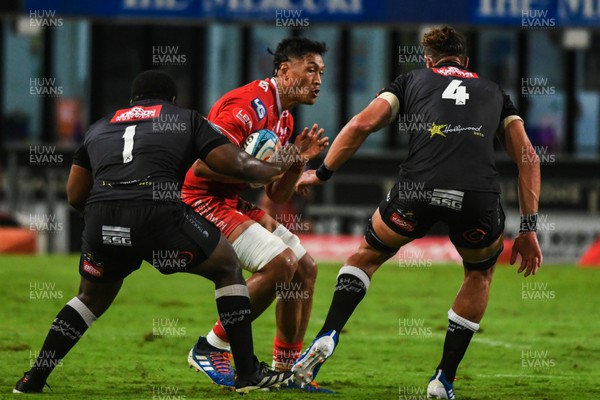 110322 - Cell C Sharks v Scarlets - United Rugby Championship - Sam Lousi of Scarlets is tackled by Ox Nche and Gerbrandt Grobler