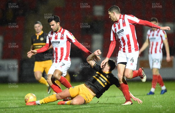 041218 - Cheltenham Town v Newport County - Checkatrade Trophy - Conor Thomas of Cheltenham Town is tackled by Charlie Cooper of Newport County
