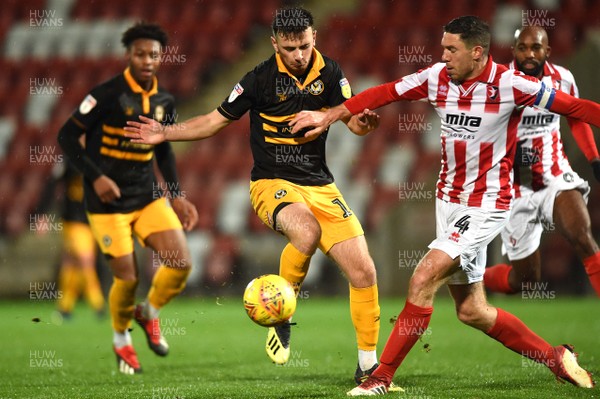 041218 - Cheltenham Town v Newport County - Checkatrade Trophy - Mark Harris of Newport County is tackled by Ben Tozer of Cheltenham Town