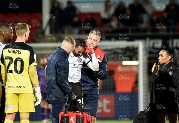 101023 - Cheltenham Town v Newport County - EFL Trophy - Aaron Wildig of Newport County is treated for a head injury