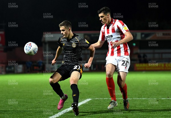 121119 - Cheltenham Town v Newport County - Leasingcom Trophy - Lewis Collins of Newport County is challenged by Jacob Greaves of Cheltenham Town