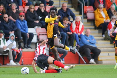 180426 - Cheltenham Town v Newport County - Sky Bet League 2 - Nathan Opoku of Newport County skips over the challenge of Harry Ashfield of Cheltenham Town