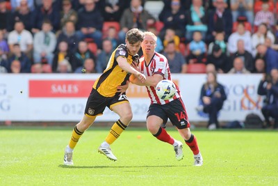 180426 - Cheltenham Town v Newport County - Sky Bet League 2 - Ben Lloyd of Newport County and Ryan Broom of Cheltenham Town battle for the ball