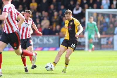 180426 - Cheltenham Town v Newport County - Sky Bet League 2 - James Crole Jenkins of Newport County gets a pass away under pressure from Luke Young of Cheltenham Town