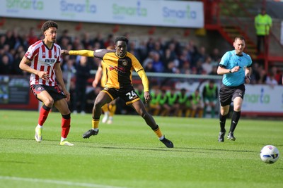 180426 - Cheltenham Town v Newport County - Sky Bet League 2 - Nathan Opoku  of Newport County slides a pass away from James Wilson of Cheltenham Town
