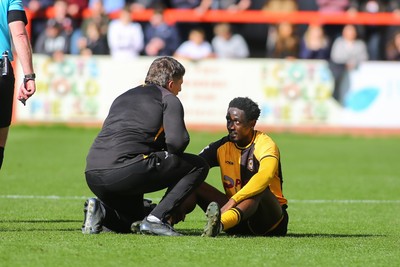 180426 - Cheltenham Town v Newport County - Sky Bet League 2 - Nathan Opoku of Newport County receives treatment for an injury before leaving the field