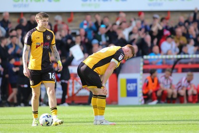 180426 - Cheltenham Town v Newport County - Sky Bet League 2 - James Crole (16) and Lee Jenkins of Newport County are dejected at the final whistle