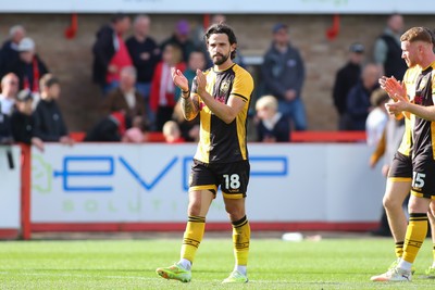 180426 - Cheltenham Town v Newport County - Sky Bet League 2 - Liam Shephard of Newport County applauds the travelling fans at the end of the game
