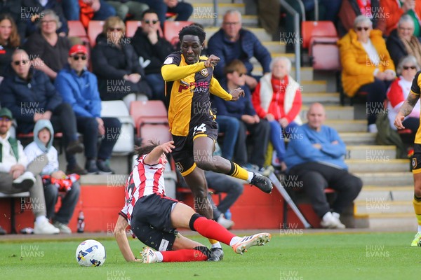 180426 - Cheltenham Town v Newport County - Sky Bet League 2 - Nathan Opoku of Newport County skips over the challenge of Harry Ashfield of Cheltenham Town