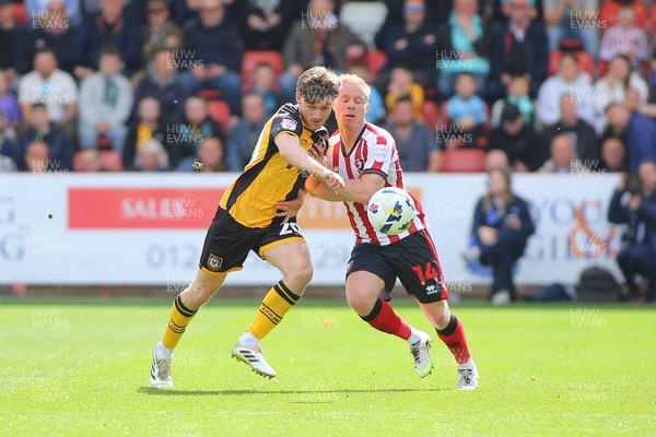 180426 - Cheltenham Town v Newport County - Sky Bet League 2 - Ben Lloyd of Newport County and Ryan Broom of Cheltenham Town battle for the ball