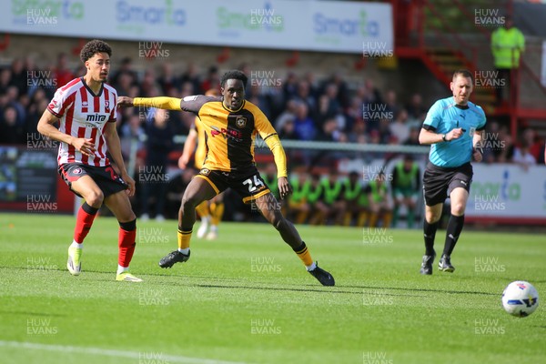 180426 - Cheltenham Town v Newport County - Sky Bet League 2 - Nathan Opoku  of Newport County slides a pass away from James Wilson of Cheltenham Town