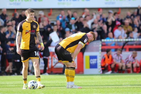 180426 - Cheltenham Town v Newport County - Sky Bet League 2 - James Crole (16) and Lee Jenkins of Newport County are dejected at the final whistle