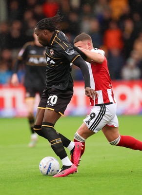 241026 Cheltenham Town v Newport County, EFL Sky Bet League 2 - Yahya Bamba of Newport County holds off Jake Evans of Cheltenham Town