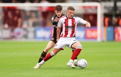 241026 Cheltenham Town v Newport County, EFL Sky Bet League 2 -  Jake Evans of Cheltenham Town holds off Joe Thomas of Newport County