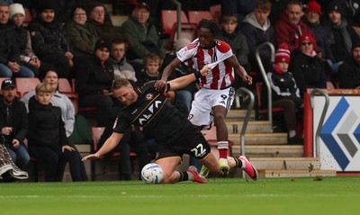 241026 Cheltenham Town v Newport County, EFL Sky Bet League 2 - Cameron Norman of Newport County is brought down by Kirsten Otchere of Cheltenham Town