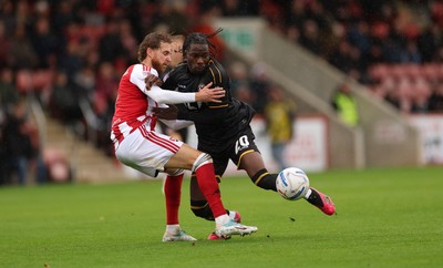 241026 Cheltenham Town v Newport County, EFL Sky Bet League 2 - Yahya Bamba of Newport County is challenged by Ben Stevenson of Cheltenham Town