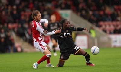 241026 Cheltenham Town v Newport County, EFL Sky Bet League 2 - Yahya Bamba of Newport County is challenged by Ben Stevenson of Cheltenham Town