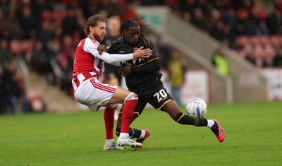 241026 Cheltenham Town v Newport County, EFL Sky Bet League 2 - Yahya Bamba of Newport County is challenged by Ben Stevenson of Cheltenham Town