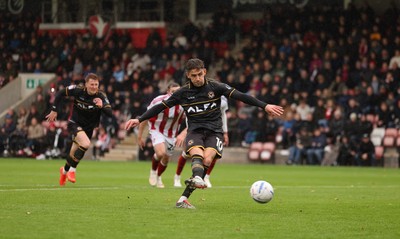241026 Cheltenham Town v Newport County, EFL Sky Bet League 2 - Harrison Biggins of Newport County takes penalty which is saved by Wyll Stanway of Cheltenham Town