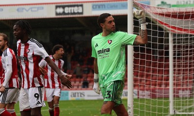 241026 Cheltenham Town v Newport County, EFL Sky Bet League 2 - Wyll Stanway of Cheltenham Town reacts to the Newport supporters after he saves penalty from Harrison Biggins of Newport County