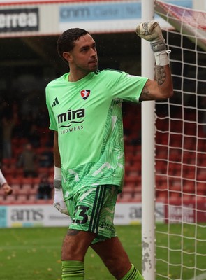 241026 Cheltenham Town v Newport County, EFL Sky Bet League 2 - Wyll Stanway of Cheltenham Town reacts to the Newport supporters after he saves penalty from Harrison Biggins of Newport County