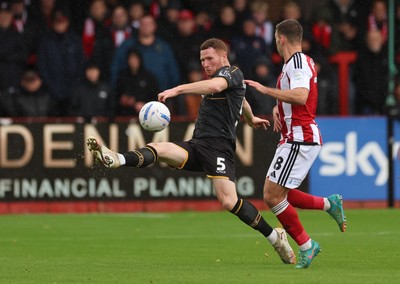 241026 Cheltenham Town v Newport County, EFL Sky Bet League 2 - Lee Jenkins of Newport County clears the ball as Charlie McCann of Cheltenham Town closes in