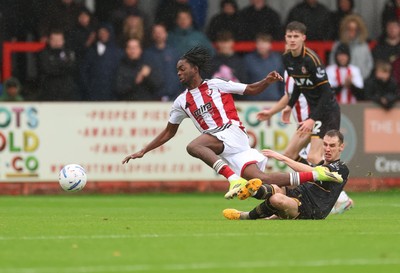 241026 Cheltenham Town v Newport County, EFL Sky Bet League 2 - Kirsten Otchere of Cheltenham Town is brought down by Ciaran Brennan of Newport County