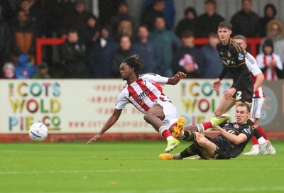 241026 Cheltenham Town v Newport County, EFL Sky Bet League 2 - Kirsten Otchere of Cheltenham Town is brought down by Ciaran Brennan of Newport County