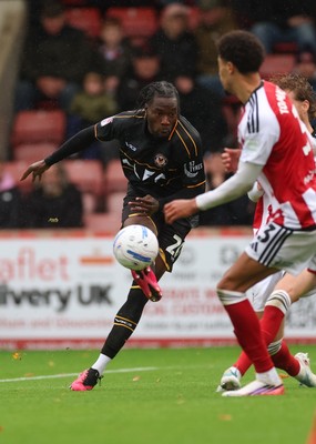241026 Cheltenham Town v Newport County, EFL Sky Bet League 2 - Yahya Bamba of Newport County shoots as Ben Stevenson of Cheltenham Town closes in