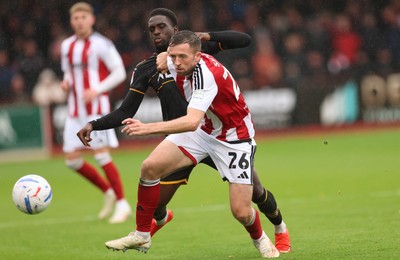 241026 Cheltenham Town v Newport County, EFL Sky Bet League 2 - Jordan Shipley of Cheltenham Town holds off Michael Adu-Poku of Newport County