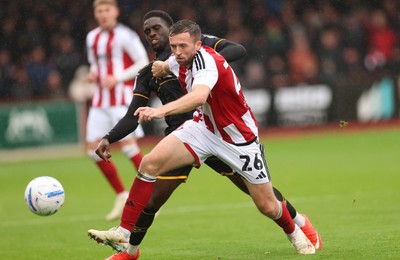 241026 Cheltenham Town v Newport County, EFL Sky Bet League 2 - Jordan Shipley of Cheltenham Town holds off Michael Adu-Poku of Newport County