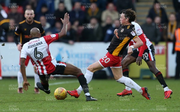 301217 - Cheltenham Town v Newport County - SkyBet League Two - Tom Owen-Evans of Newport County is tackled by Nigel Atangana of Cheltenham Town