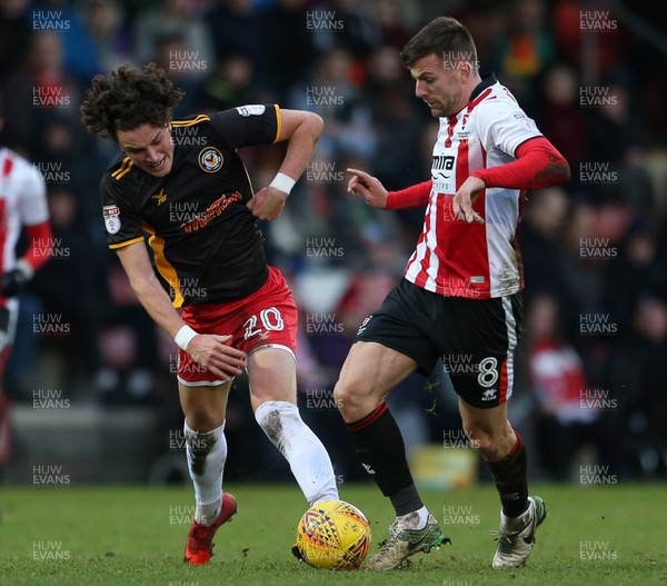 301217 - Cheltenham Town v Newport County - SkyBet League Two - Tom Owen-Evans of Newport County is tackled by Kevin Dawson of Cheltenham Town
