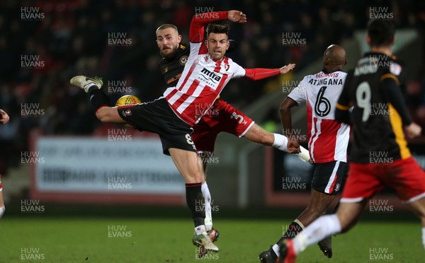 301217 - Cheltenham Town v Newport County - SkyBet League Two - Kevin Dawson of Cheltenham Town and Dan Butler of Newport County go up for the ball