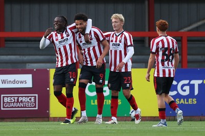 230725 - Cheltenham Town v Swansea City - Pre Season Friendly - Lee Angol of Cheltenham Town celebrates scoring a goal with team mates