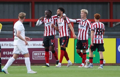 230725 - Cheltenham Town v Swansea City - Pre Season Friendly - Lee Angol of Cheltenham Town celebrates scoring a goal with team mates
