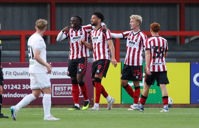 230725 - Cheltenham Town v Swansea City - Pre Season Friendly - Lee Angol of Cheltenham Town celebrates scoring a goal with team mates