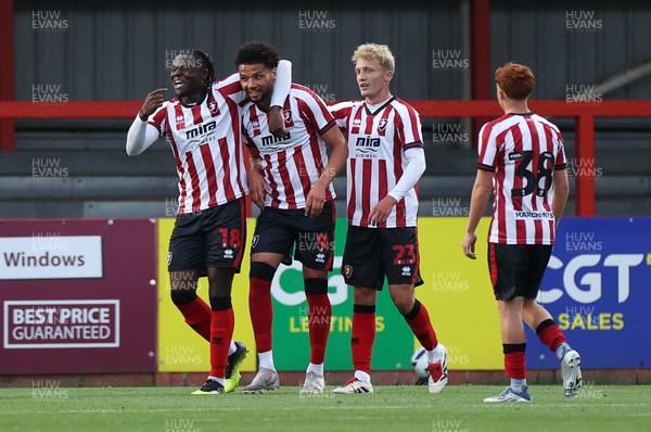 230725 - Cheltenham Town v Swansea City - Pre Season Friendly - Lee Angol of Cheltenham Town celebrates scoring a goal with team mates