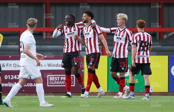 230725 - Cheltenham Town v Swansea City - Pre Season Friendly - Lee Angol of Cheltenham Town celebrates scoring a goal with team mates