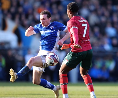 080325 - Chesterfield v Newport County - Sky Bet League 2 - Bobby Kamwa of Newport shot is blocked by Liam Mandeville of Chesterfield