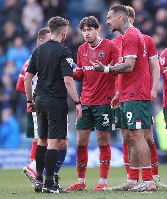 080325 - Chesterfield v Newport County - Sky Bet League 2 - Anthony Glennon of Newport and Courtney Baker-Richardson of Newport confront referee Michael Barlow at the end of the match