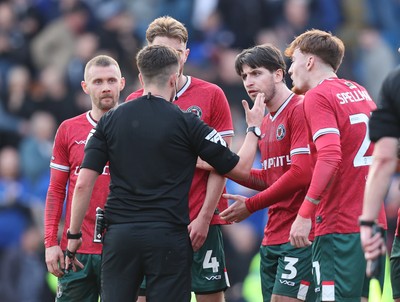 080325 - Chesterfield v Newport County - Sky Bet League 2 - Kieron Evans of Newport Matt Baker of Newport Anthony Glennon of Newportand Michael Spellman of Newport confront the referee Michael Barlow at the end of the match