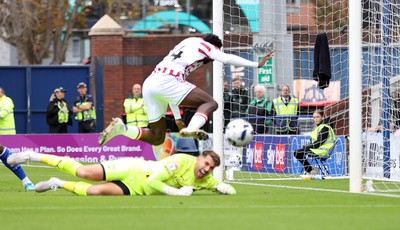 270925 - Chesterfield v Newport County - Sky Bet League 2 - Nathan Opoku of Newport falls over Goalkeeper Zach Hemming of Chesterfield